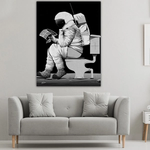 Detail of creative astronaut reading newspaper wall art above a grey fabric sofa