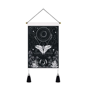 Moth and moon phase wall tapestry with geometric stars and floral patterns in black and white