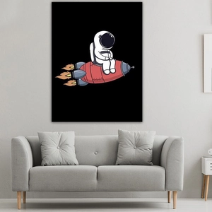 Cartoon astronaut riding a rocket art print hanging on a gray wall above a sofa