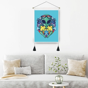 Alien wall tapestry with wooden rod and black tassels in a modern living room