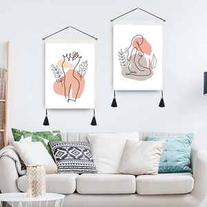 Minimalist female line art wall tapestries with tassels in a modern living room setting