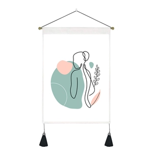 Detail of minimalist line art wall tapestry with pink geometric shapes and black tassels