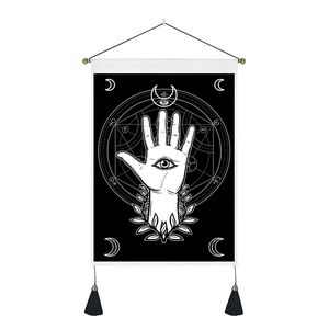 Detail of bohemian wall hanging featuring mystical Hamsa hand and crescent moon motifs