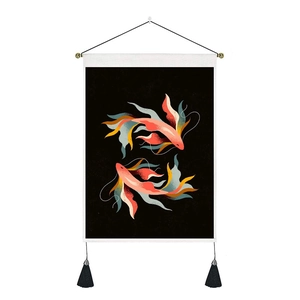 Detailed view of modern wall tapestry with golden fish art and black hanging tassels