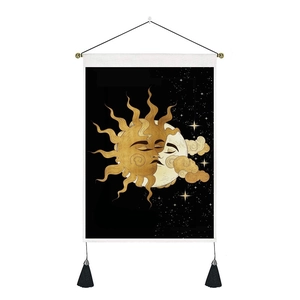 Detail of bohemian sun and moon tapestry with celestial pattern, hanging rod and tassels