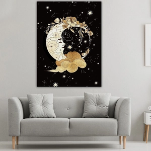 Detail of moon goddess tapestry with gold floral and star patterns above a modern sofa