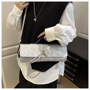 Détail du sac à main argenté à motif crocodile avec fermoir en métal et bandoulière