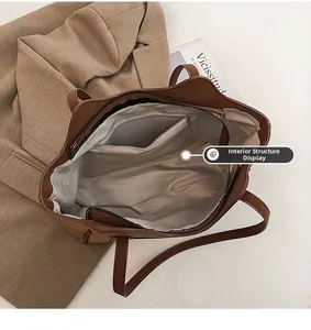 Detailed interior of large brown tote bag showing zipper pocket and spacious layout