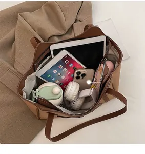 Interior view showing large capacity of the brown tote bag for laptop and daily essentials