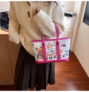 Close-up of graffiti tote bag with colorful pink trim and artistic bear prints