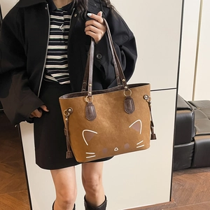 Brown suede tote bag with minimalist white cartoon cat print and leather handles