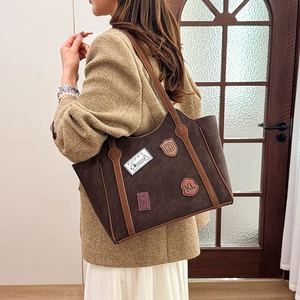 Retro dark brown suede tote bag with vintage patches and light brown leather handles