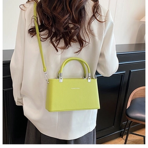 Neon green trapezoid handbag in lychee-grain faux leather with a chic shoulder strap