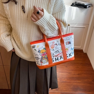 Chic graffiti bucket tote bag with bear print and orange leather handles for women