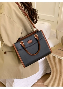 Close-up of retro color-block tote bag with litchi texture and adjustable strap