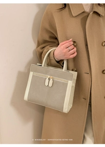 Detailed side view of minimalist gray matte tote bag with dual gold zippers
