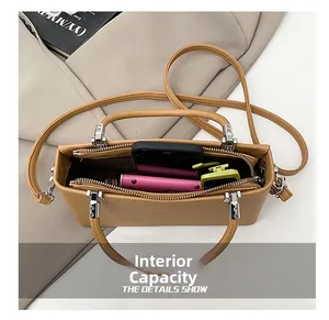 Top view of compact leather handbag interior showing storage for phone and wallet
