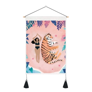 Detail of artistic tiger and girl tapestry featuring wood hanger and black bottom tassels