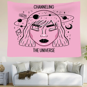 Detail of pink celestial tapestry featuring moon goddess art and galaxy print on a wall