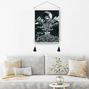 Gothic skull tapestry with crown and moon hanging above a modern living room sofa