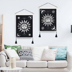 Bohemian sun and moon wall art set with black tassels and wooden hanging rods