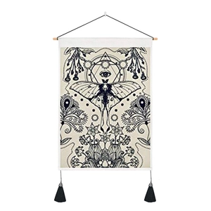 Nordic butterfly canvas tapestry with tassel accents and mystic eye patterns on white wall