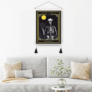Skull Magician Tarot tapestry with wooden rod and black tassels on a white wall