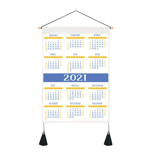 Detail of 2021 wall calendar tapestry with wooden rod and black tassel accents