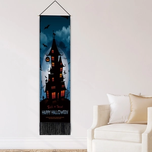 Happy Halloween tapestry with ghost castle design and tassels hanging on a modern white wall