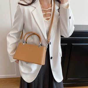 Structured caramel leather handbag with lychee pattern and adjustable shoulder strap
