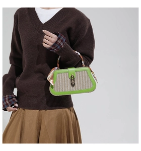 Detail of straw and green leather handbag with scarf handle and chain lock closure