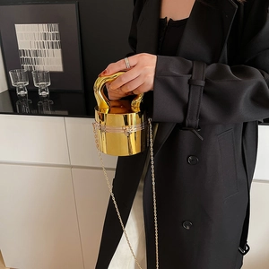 Chic gold cylindrical acrylic clutch with mirror finish and metallic handle for evening
