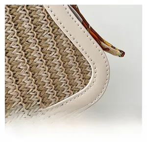 Detail of beige straw texture with white faux leather piping and floral silk ribbon puller