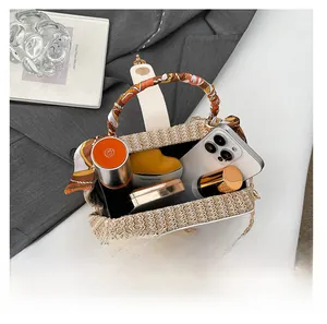 Top view of woven handbag showing interior capacity with smartphone and cosmetics