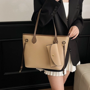 Grand sac cabas rétro kaki avec bandoulières brunes et pochette porté par un mannequin