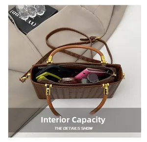 Interior view of brown woven box bag showing space for phone, wallet and cosmetics