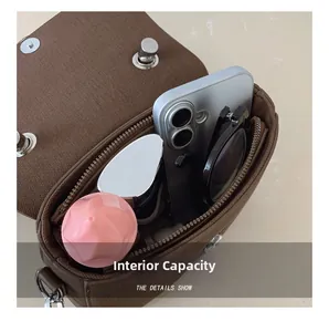 Detail of spacious internal capacity of the brown canvas bag with multiple items