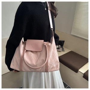 Pink pleated large capacity travel bag with top handle and shoulder strap detail