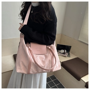 Pink large capacity travel tote bag with ruched texture shown in a modern lifestyle setting