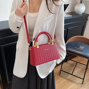 Elegant red box bag with woven texture, golden metal handle and adjustable strap for women