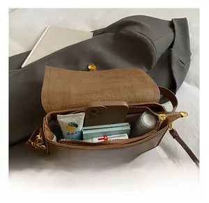 Interior view showing the large capacity and pockets of the brown patchwork shoulder bag