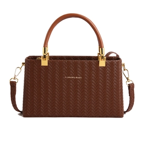 Dark brown woven texture handbag with top handle and gold hardware in front view