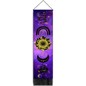 Macro detail of mystical moon child sun tapestry featuring black fringe and purple fabric