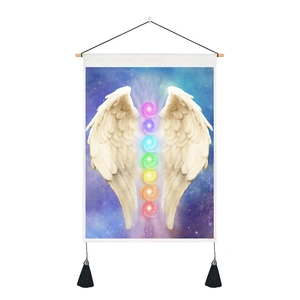 Detail of colorful chakra symbols and white wings on a dark starry tapestry with tassels