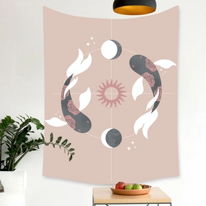 Boho tapestry with koi fish and sun pattern hanging on a white wall in a cozy room