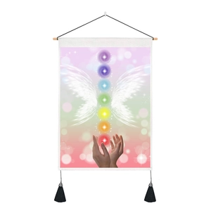 Detail of spiritual chakra wall tapestry with colorful wings and wooden hanging rod