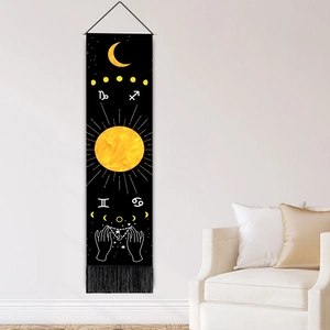 Astrological tapestry with moon phases and zodiac motifs hanging on a white wall