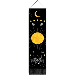 Detail of moon phases and zodiac symbols on black wall tapestry with fringe