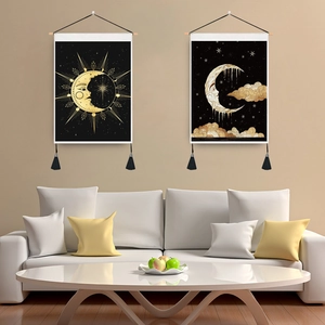 Two-piece sun and moon tapestry set with black background and gold fringe for wall decor