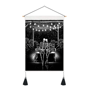 Smiling skeletons on bench tapestry with night sky print, wooden rod and black tassels